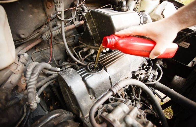 Pouring new oil in a car