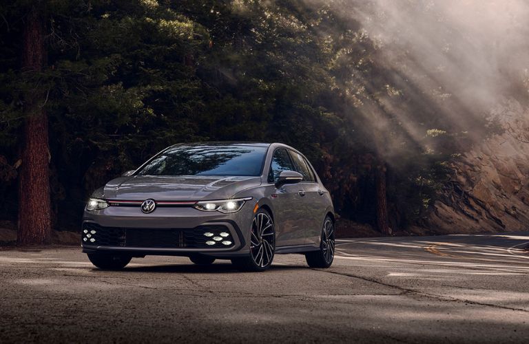 A 2022 Volkswagen Golf GTI on a smooth road on a sunny day